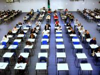 The photo shows students taking a written exam